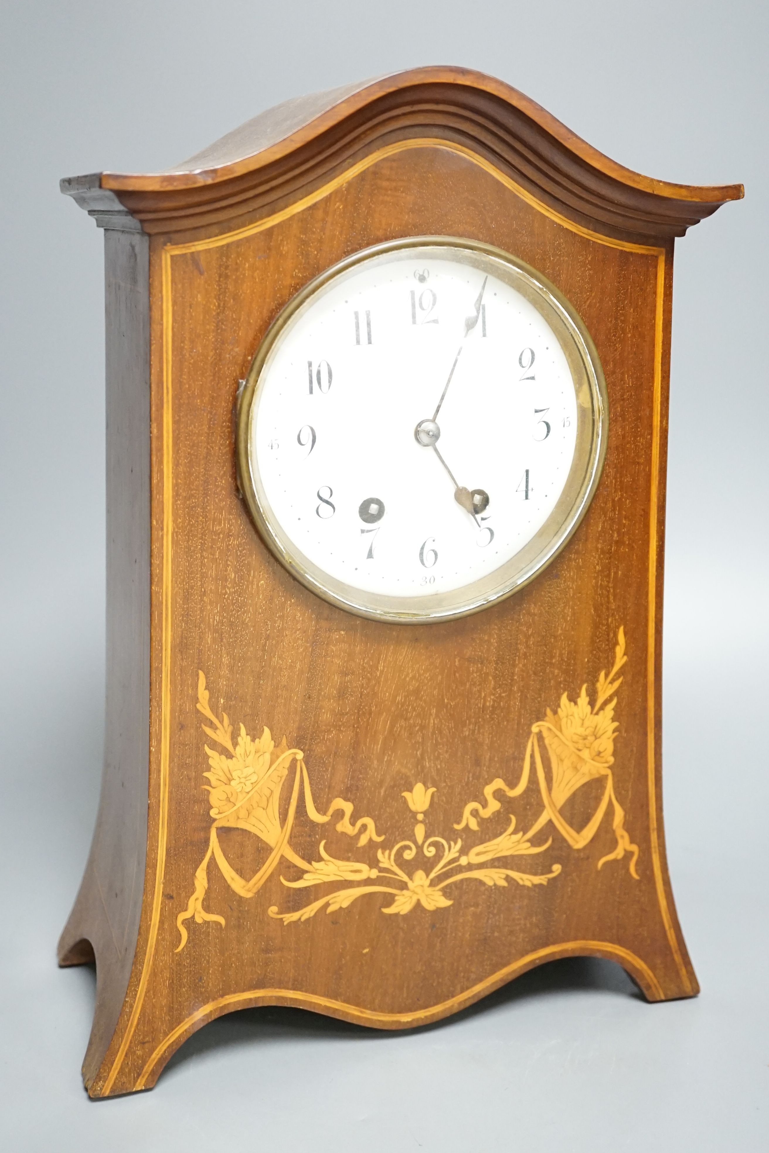 An Edwardian inlaid mahogany mantel clock with French gong-striking movement, 39cm.